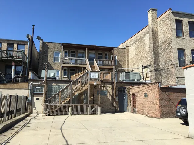 a view of a roof deck with couches and wooden floor