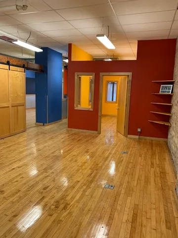 a view of an empty room with kitchen