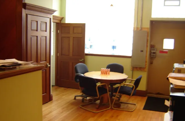 a view of a dining room with furniture and a window