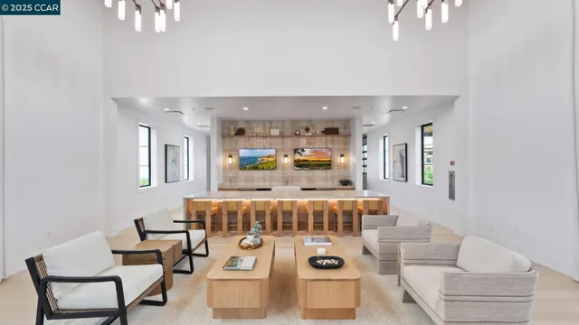 a view of an empty room with wooden floor and windows