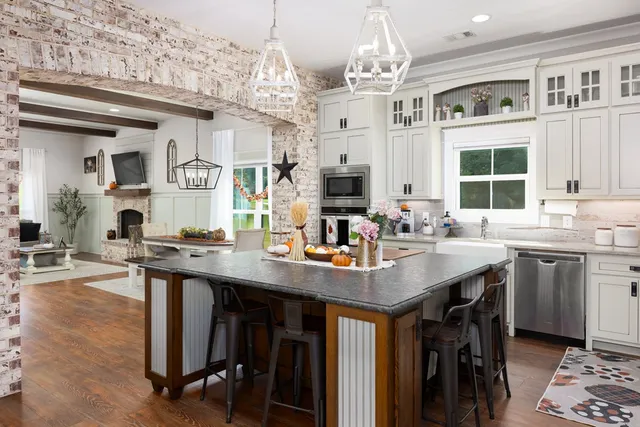a kitchen with cabinets table and chairs