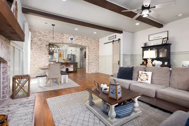 a living room with furniture and a chandelier