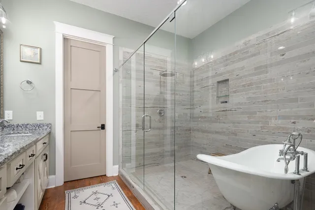 a bathroom with a bathtub and shower