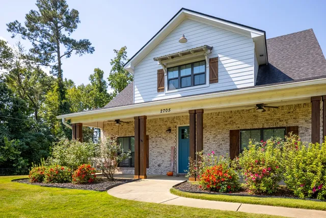 a front view of a house with garden