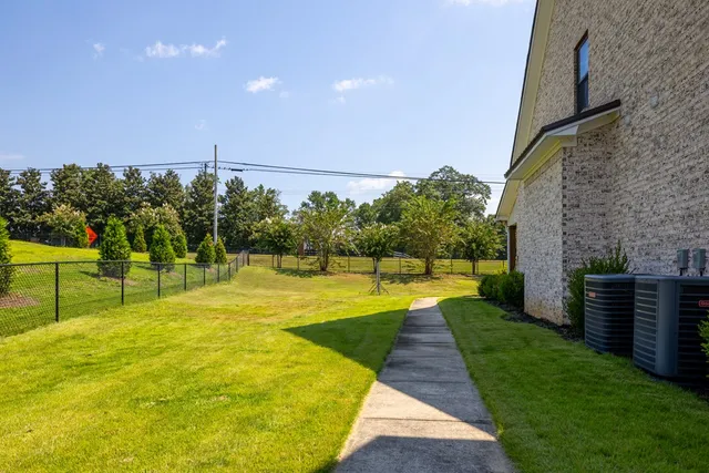 a view of a swimming pool with a garden and plants