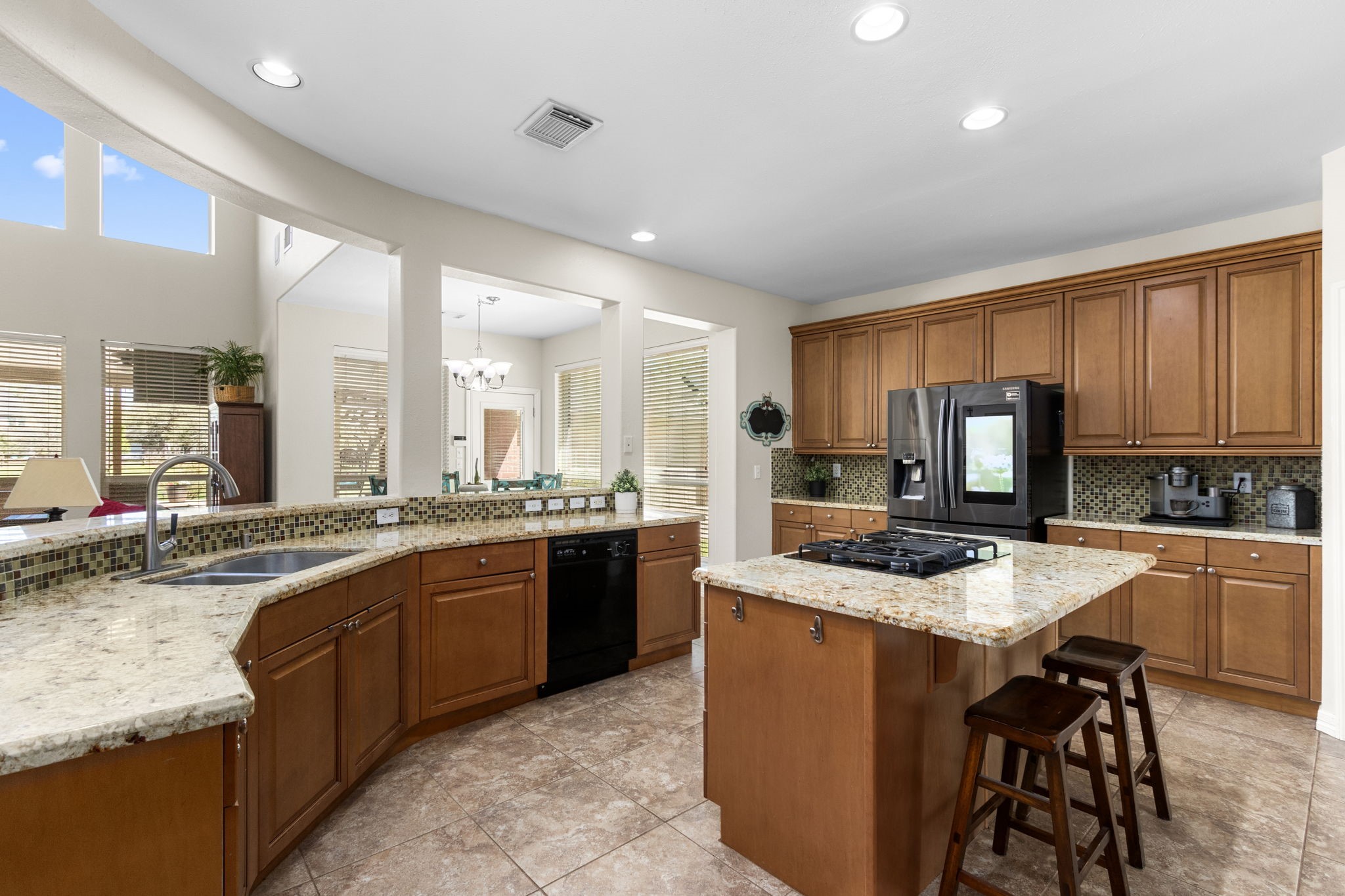 3610 Wellspring Lake Drive Fulshear, TX 77441 - Photo 14 of 45 a kitchen with stainless steel appliances granite countertop a sink counter space cabinets and a stove