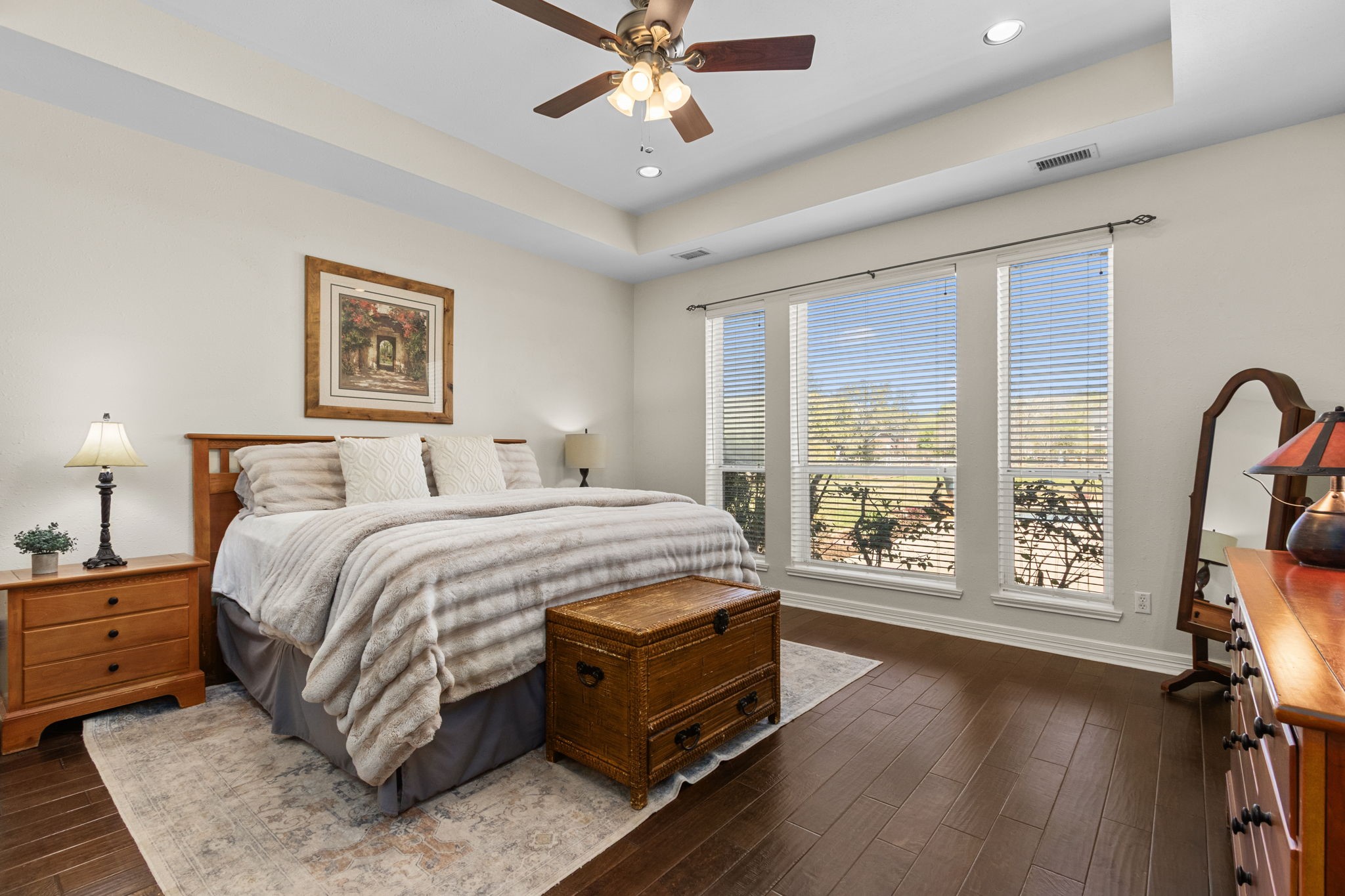 3610 Wellspring Lake Drive Fulshear, TX 77441 - Photo 19 of 45 a spacious bedroom with a bed a flat screen tv and a large window with the outer view