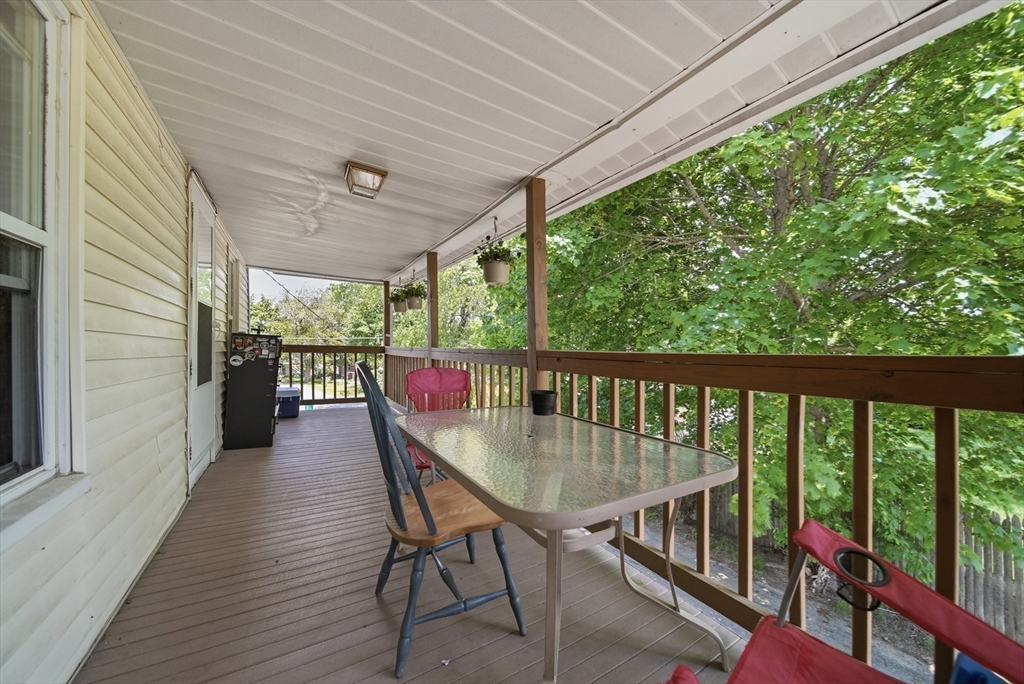 436 Franklin Road Fitchburg, MA 01420 - Photo 21 of 41 a balcony with wooden floor table and chairs