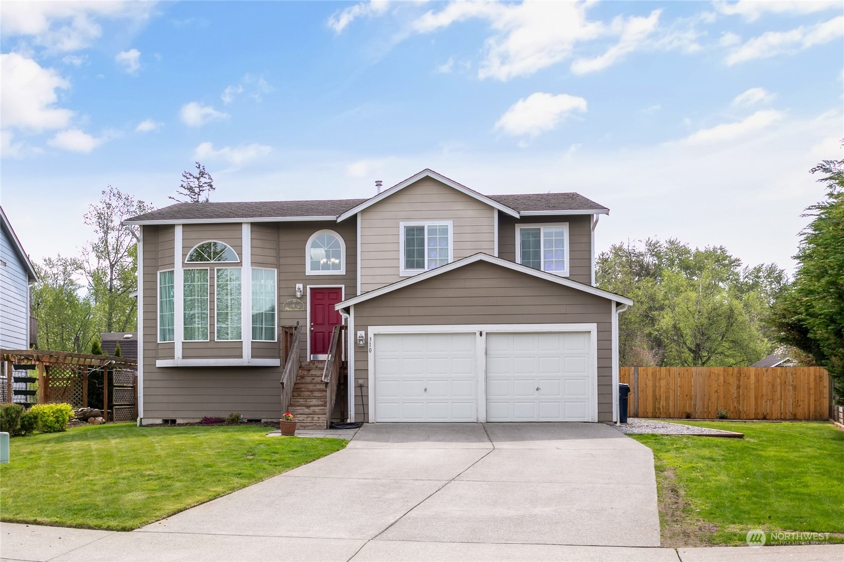 310 Allison Way Nooksack, WA 98276 - Photo 1 of 35 a front view of a house with a yard and garage