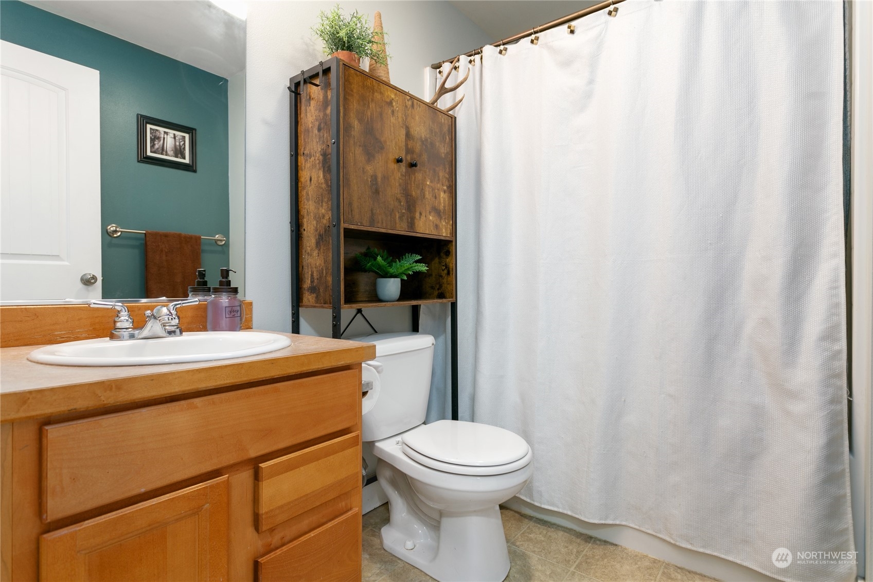 310 Allison Way Nooksack, WA 98276 - Photo 19 of 35 a bathroom with a sink a toilet and shower curtain