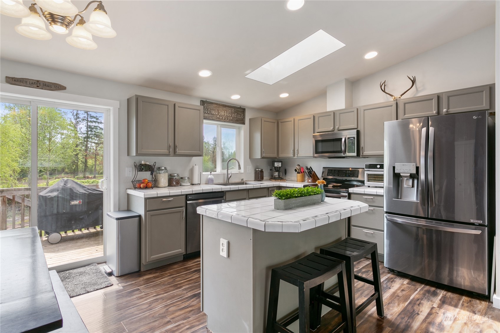 310 Allison Way Nooksack, WA 98276 - Photo 9 of 35 a kitchen with a refrigerator a stove a sink dishwasher with a dining table and chairs