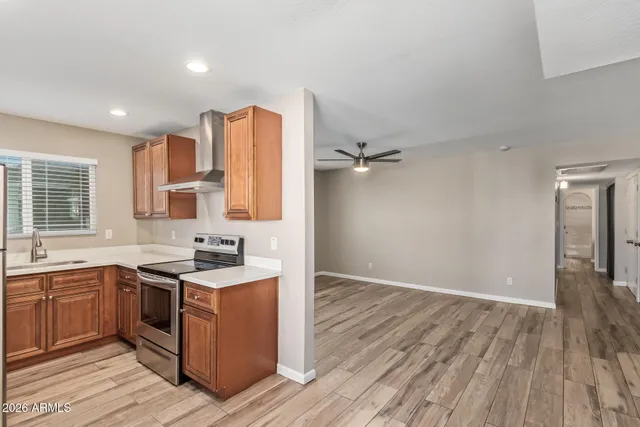 a view of a kitchen with wooden floor and electronic appliances