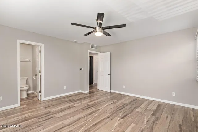 a view of an empty room and wooden floor