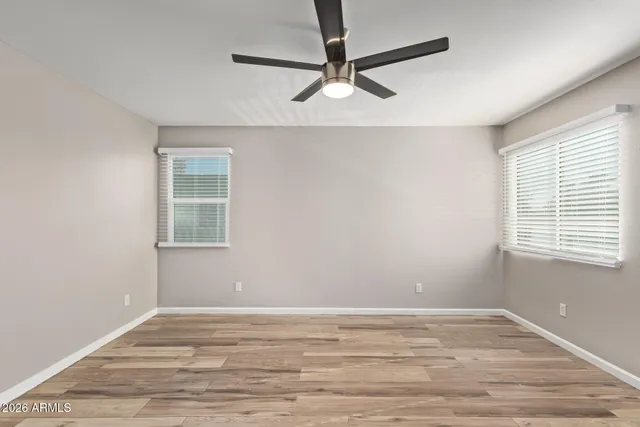 a view of a room with window and a ceiling fan