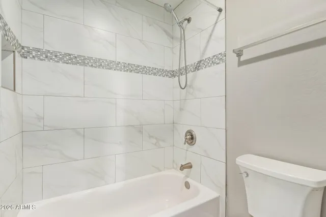 a bathroom with a shower and a toilet