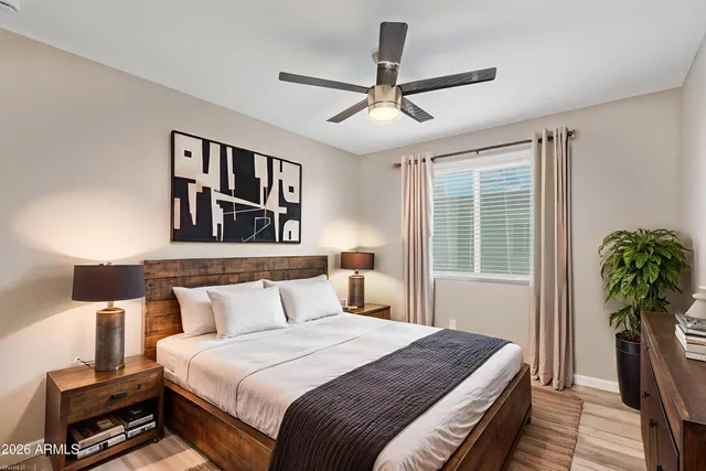 a bedroom with a large bed and a chandelier