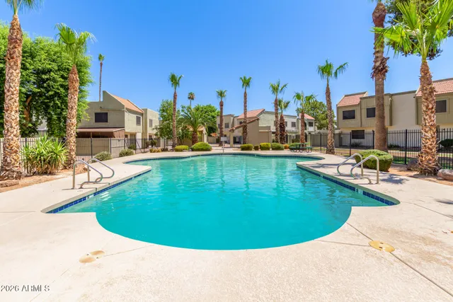 a view of a swimming pool with outdoor seating