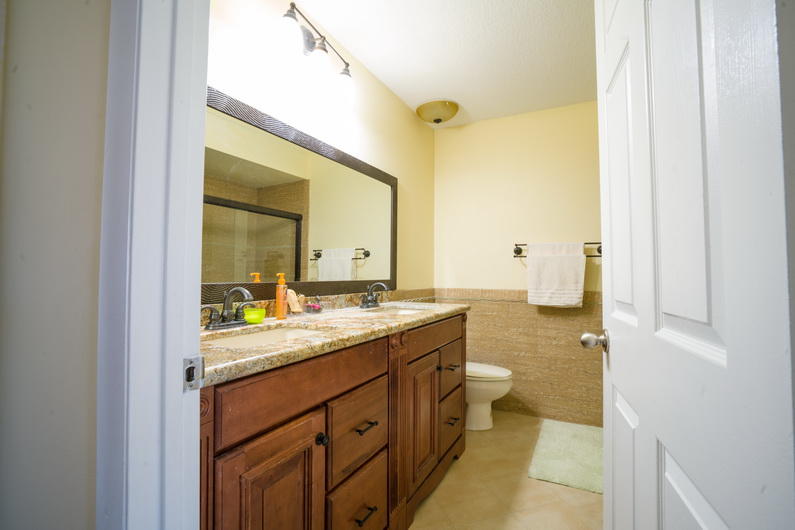 9721 Enchanted Pointe Lane Boca Raton, FL 33496 - Photo 12 of 25 a bathroom with a granite countertop sink mirror and a toilet