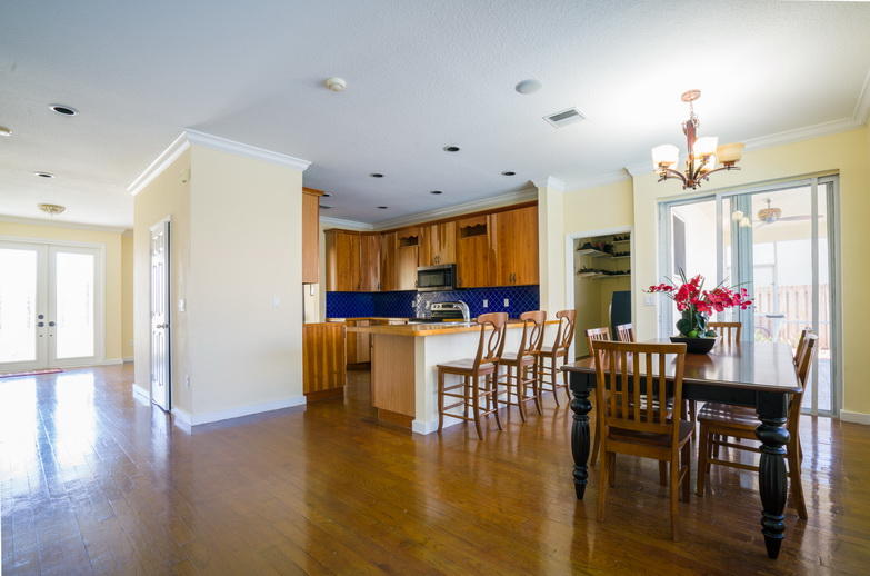 9721 Enchanted Pointe Lane Boca Raton, FL 33496 - Photo 4 of 25 a view of a dining room with furniture and wooden floor