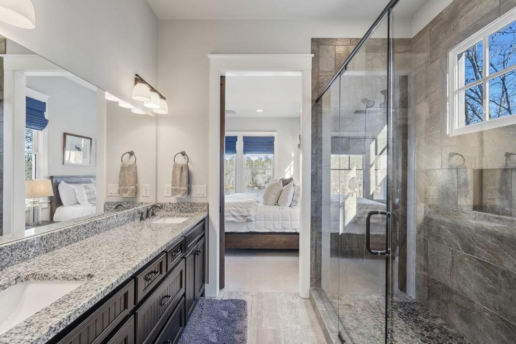 72 Buckeye Ridge Newnan, GA 30263 - Photo 22 of 80 a spacious bathroom with a granite countertop sink mirror and shower