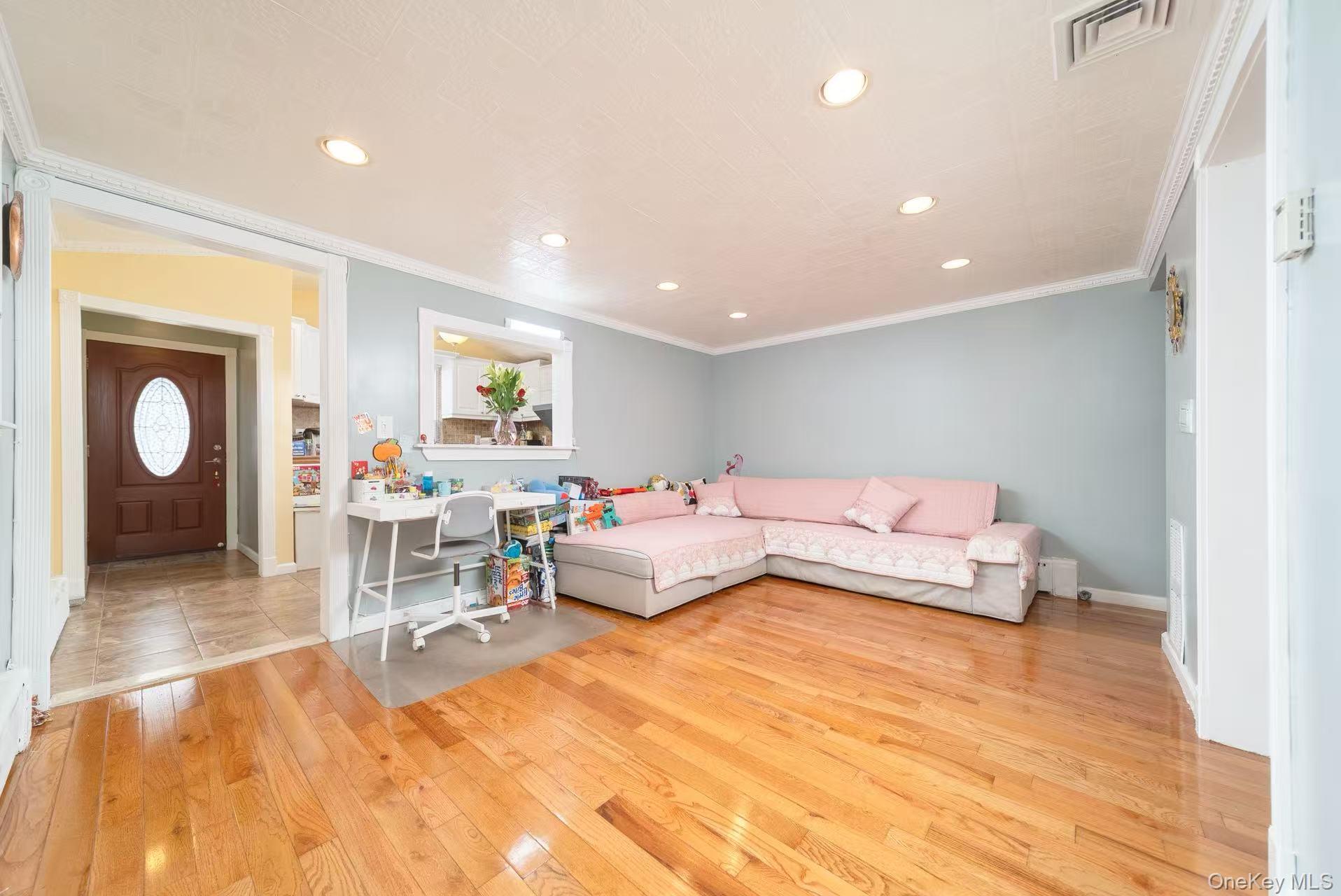 10 Church Street Queens, NY 11414 - Photo 11 of 19 Living room with crown molding, light wood-style floors, and recessed lighting