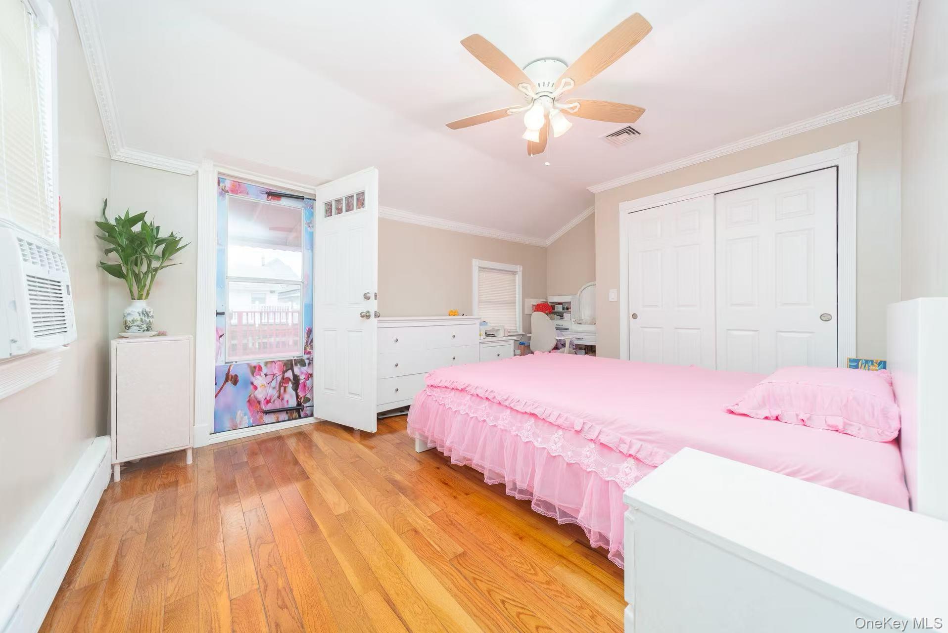 10 Church Street Queens, NY 11414 - Photo 13 of 19 Bedroom with crown molding, light wood-style floors, a ceiling fan, a closet, and cooling unit
