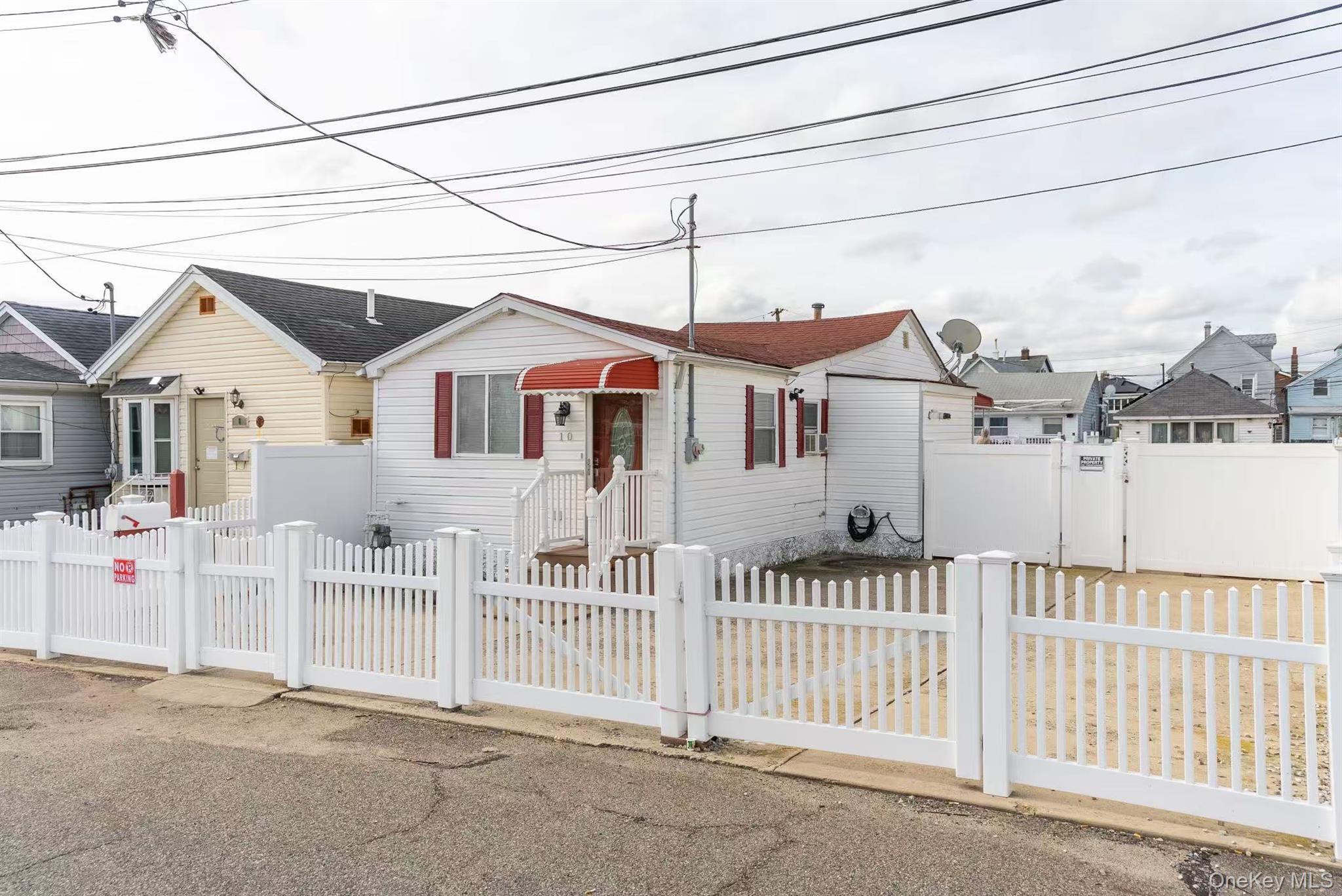 10 Church Street Queens, NY 11414 - Photo 3 of 19 View of front of house with a gate, a fenced front yard, and a residential view