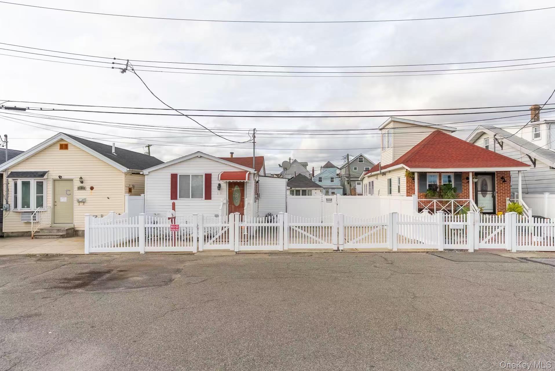 10 Church Street Queens, NY 11414 - Photo 4 of 19 Bungalow-style home featuring a fenced front yard, a residential view, and a gate