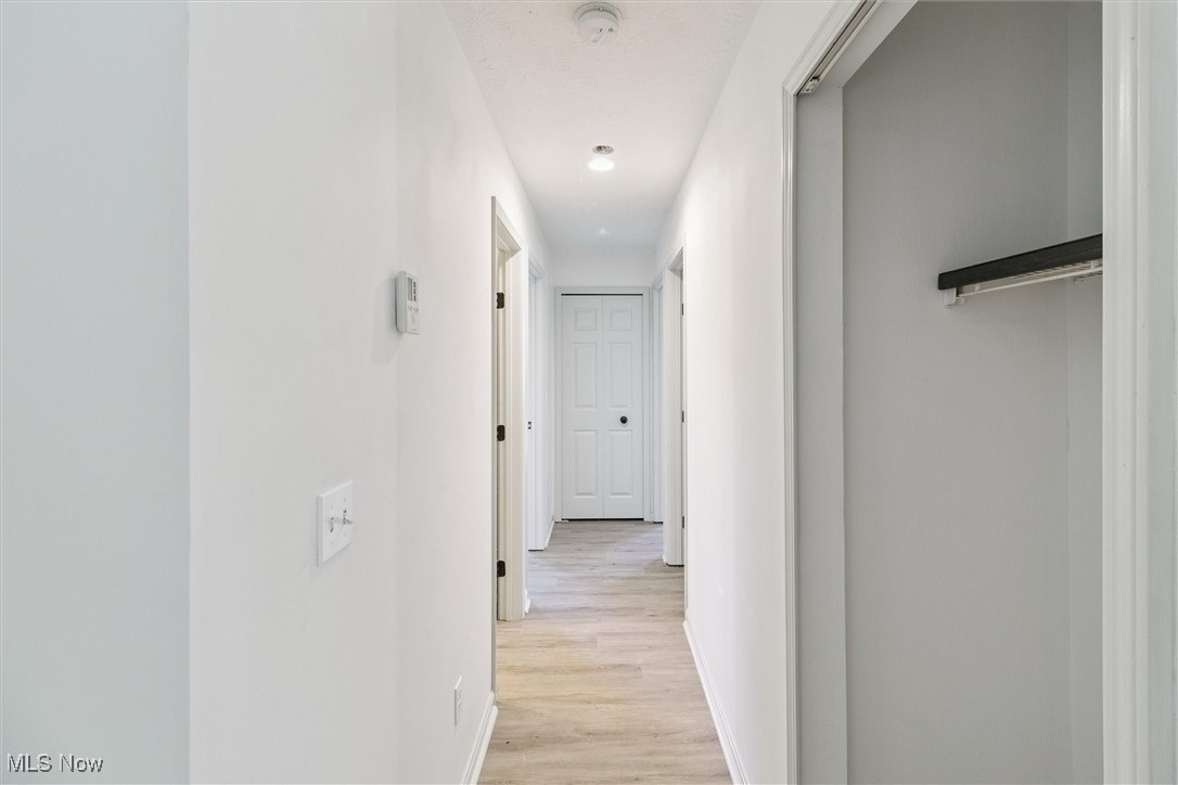 3930 Wood Road Madison, OH 44057 - Photo 26 of 45 Corridor featuring baseboards and light wood-style flooring