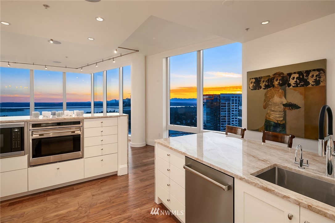 10700 Northeast 4th Street, Unit 4202 Bellevue, WA 98004 - Photo 11 of 40 a kitchen with stainless steel appliances kitchen island granite countertop a sink and cabinets