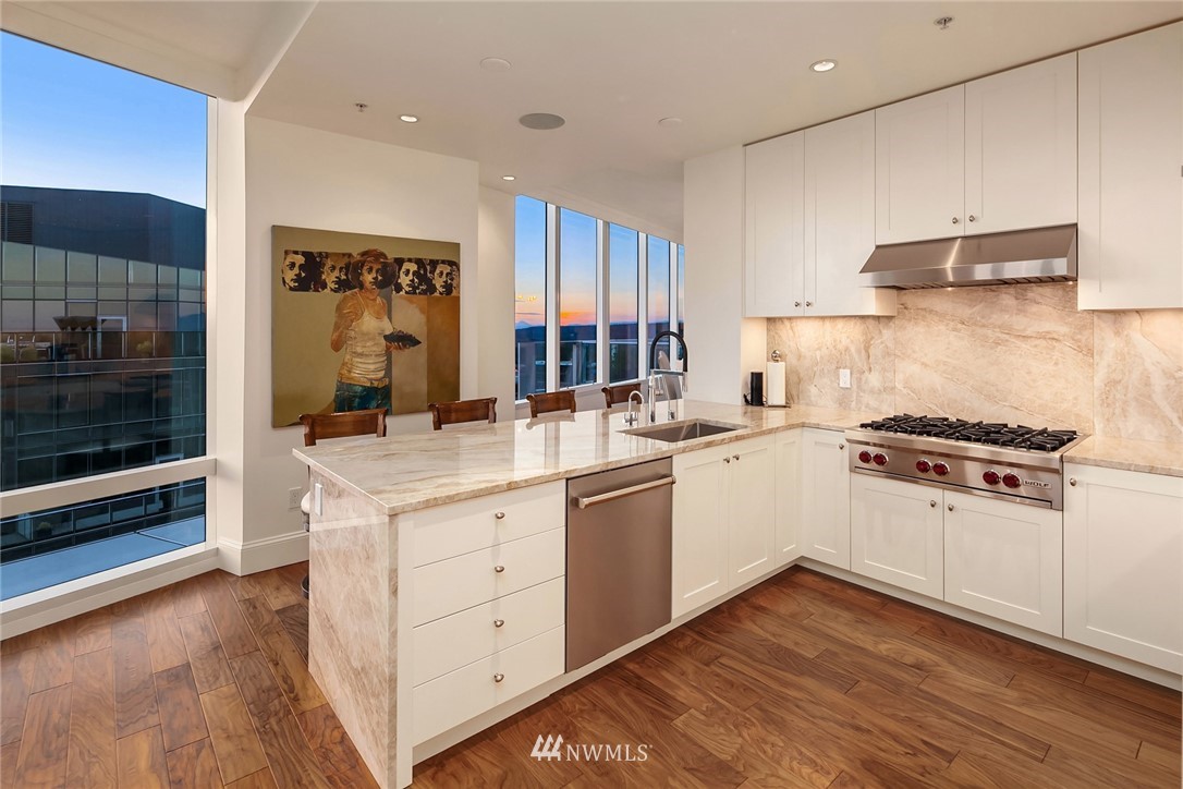 10700 Northeast 4th Street, Unit 4202 Bellevue, WA 98004 - Photo 12 of 40 a kitchen with a sink stove and cabinets