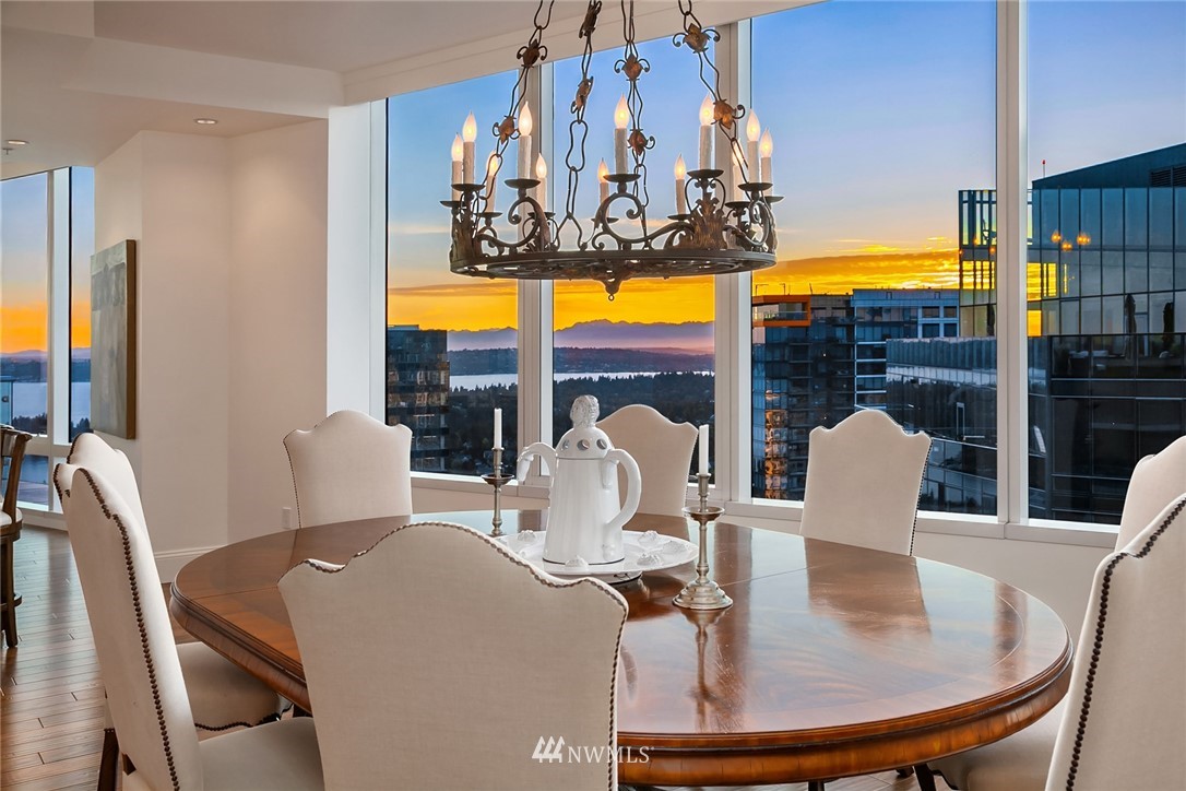 10700 Northeast 4th Street, Unit 4202 Bellevue, WA 98004 - Photo 16 of 40 a dining room with furniture a flat screen tv and a large window