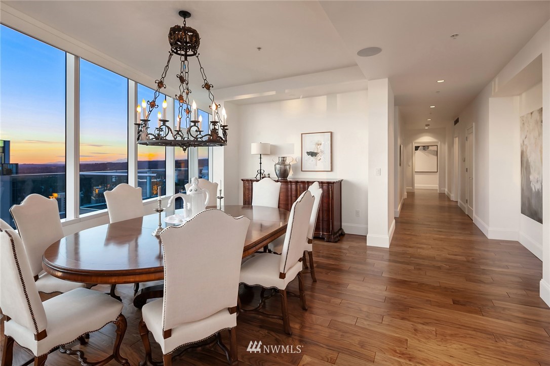 10700 Northeast 4th Street, Unit 4202 Bellevue, WA 98004 - Photo 17 of 40 a view of a dining room with furniture a chandelier and wooden floor