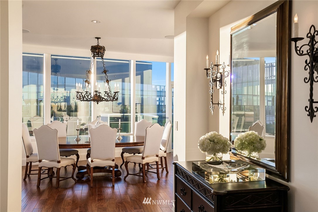 10700 Northeast 4th Street, Unit 4202 Bellevue, WA 98004 - Photo 19 of 40 a dining room with furniture a chandelier and wooden floor