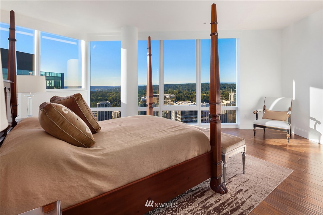 10700 Northeast 4th Street, Unit 4202 Bellevue, WA 98004 - Photo 26 of 40 a bedroom with a bed a chair and a large window