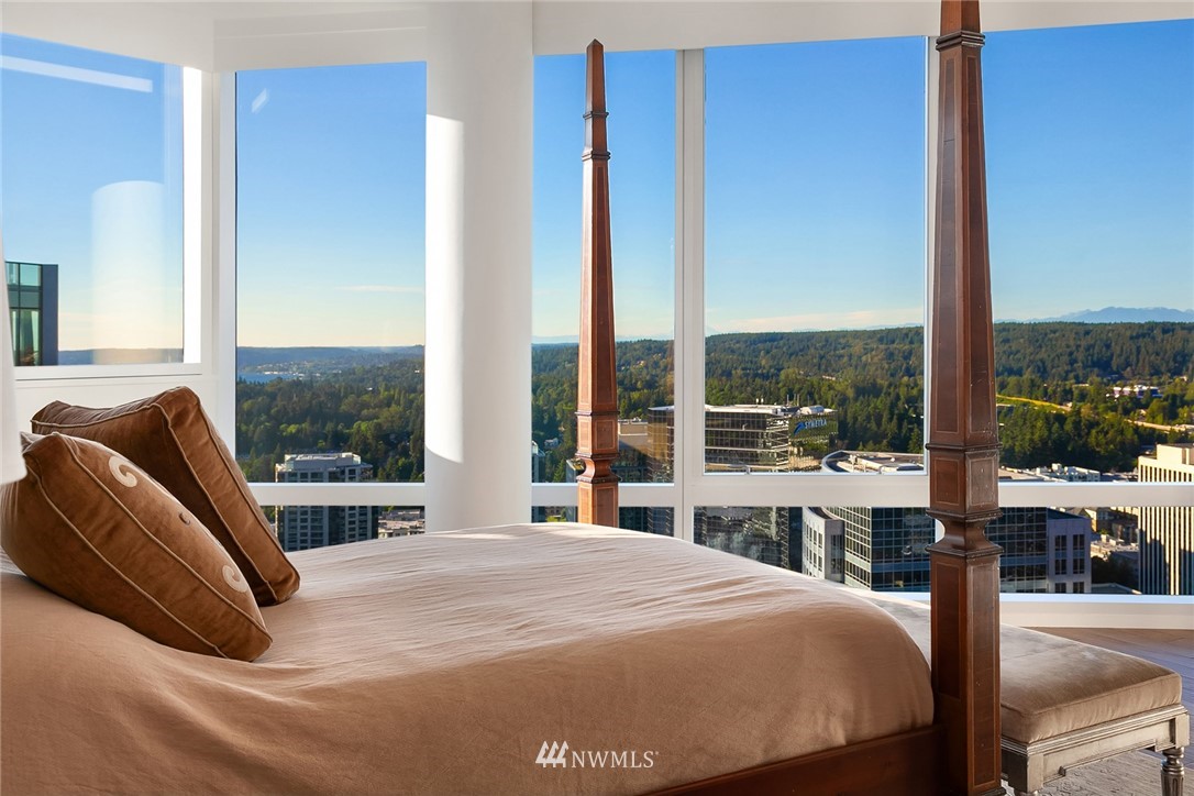 10700 Northeast 4th Street, Unit 4202 Bellevue, WA 98004 - Photo 27 of 40 a bedroom with a bed and glass window