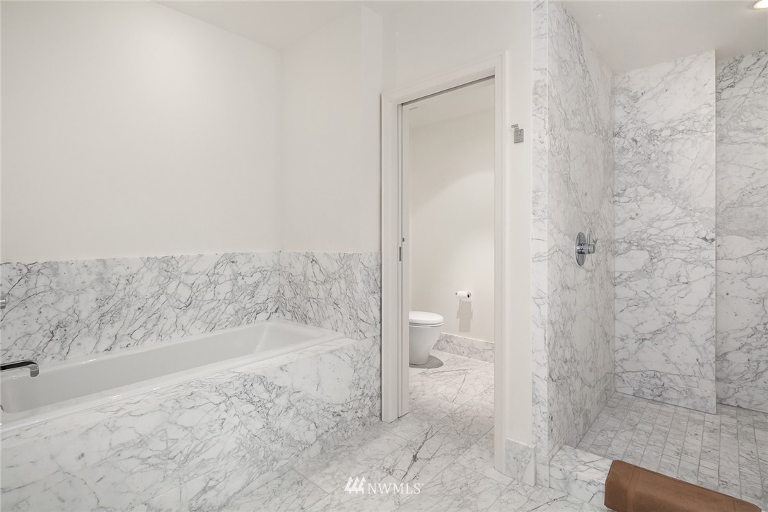 10700 Northeast 4th Street, Unit 4202 Bellevue, WA 98004 - Photo 29 of 40 a bathroom with a bathtub and a shower