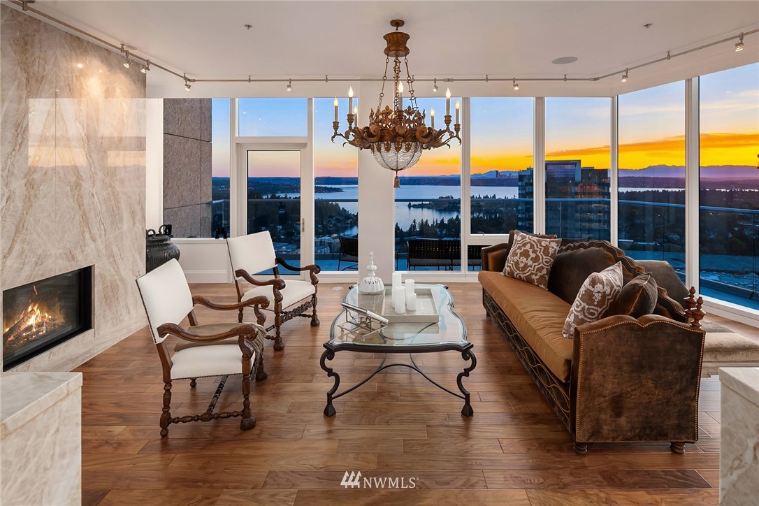10700 Northeast 4th Street, Unit 4202 Bellevue, WA 98004 - Photo 4 of 40 a living room with fireplace furniture and a floor to ceiling window