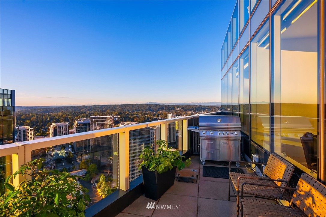 10700 Northeast 4th Street, Unit 4202 Bellevue, WA 98004 - Photo 32 of 40 a view of a balcony with chairs and wooden floor