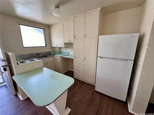 a kitchen with stainless steel appliances granite countertop a refrigerator a stove a sink dishwasher and a refrigerator with wooden floor