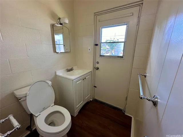 a white toilet sitting in a bathroom next to a sink