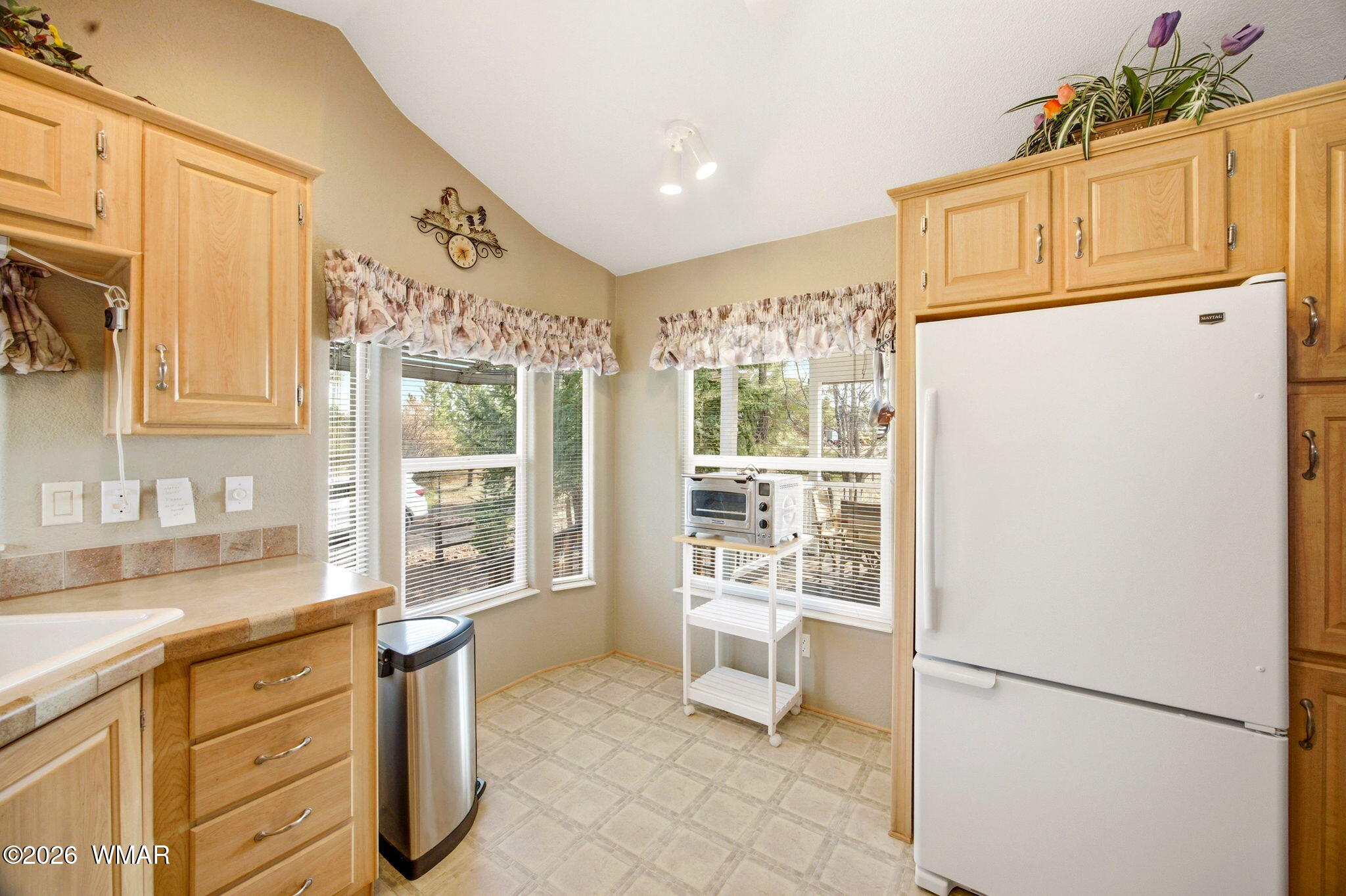 2275 Old Crooks Trail Overgaard, AZ 85933 - Photo 12 of 24 a kitchen with granite countertop cabinets and refrigerator