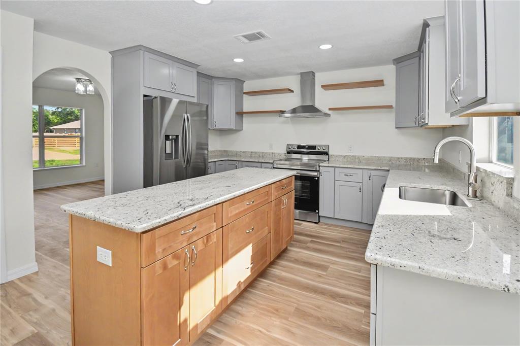 4948 Cromey Road North Port, FL 34288 - Photo 9 of 30 a kitchen with stainless steel appliances granite countertop a sink stove and refrigerator