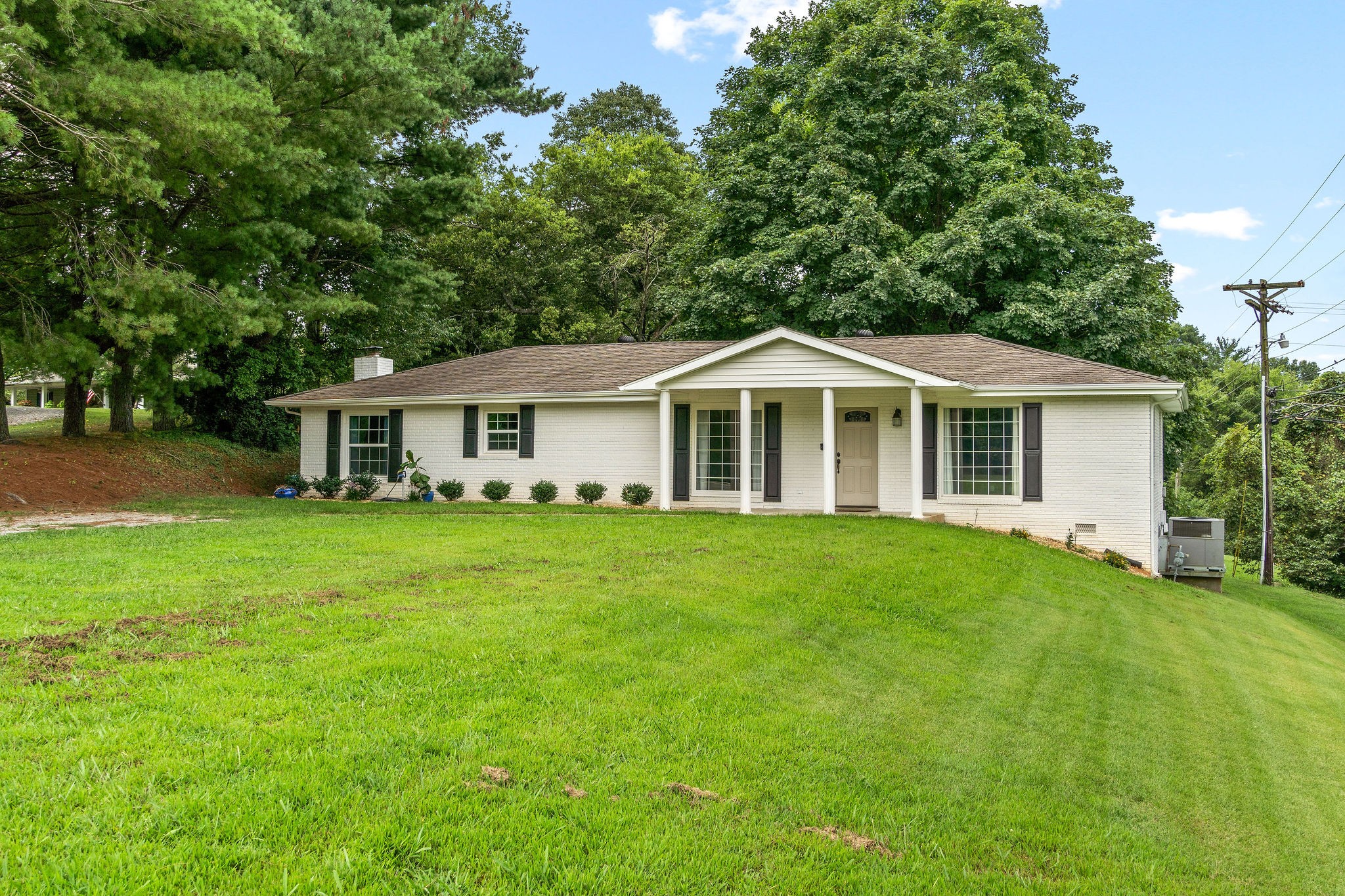 a front view of a house with a garden