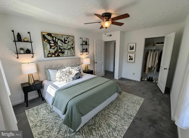 a bedroom with a rug bed and a chandelier