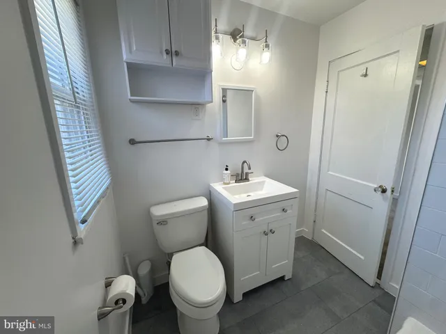 a bathroom with a tub and a window