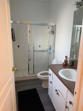 a bed sitting in a spacious bedroom next to a window