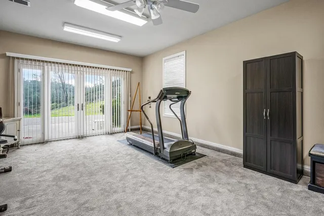 a front view of a house with a yard and potted plants
