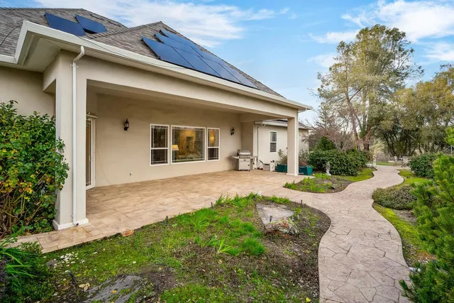 a view of a backyard with sitting area