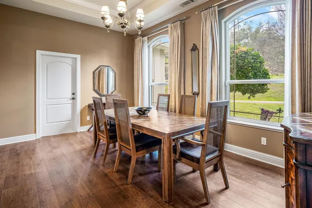 a dining room with furniture and wooden floor